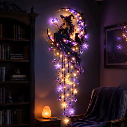 Witch on the moon suncatcher glowing on a bedroom wall at night